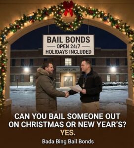photo shows a man shaking hands with a bail agent outside a snowy "County Jail" at night, under a lit holiday archway. A sign above them reads, "BAIL BONDS - OPEN 24/7 - HOLIDAYS INCLUDED." Text at the bottom asks, "CAN YOU BAIL SOMEONE OUT ON CHRISTMAS OR NEW YEAR'S? YES. Bada Bing Bail Bonds."