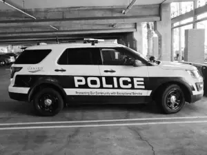 Exterior view of the Bada Bing Bail Bonds office in Oxnard, California, showing a bail agent talking on the phone outside and staff working inside, with signage advertising low money down, military, and union discounts.