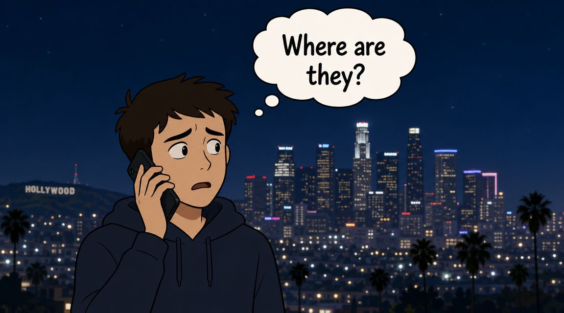 A concerned young man on a phone call looking at the Los Angeles city skyline at night.