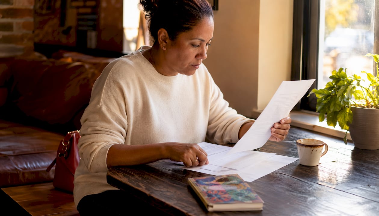 Woman reviewing jail visitation rules at home table