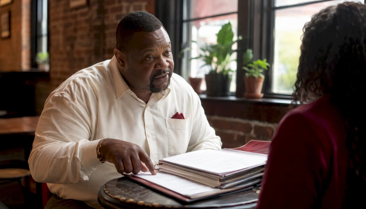 Bail bondsman explaining court orders at office