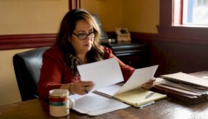 Woman reviewing bail paperwork at jail office desk