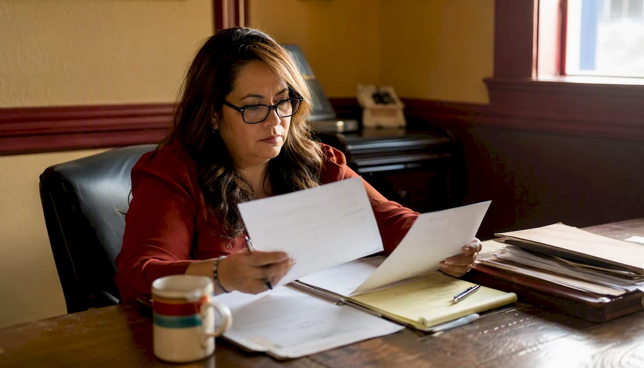 Woman reviewing bail paperwork at jail office desk