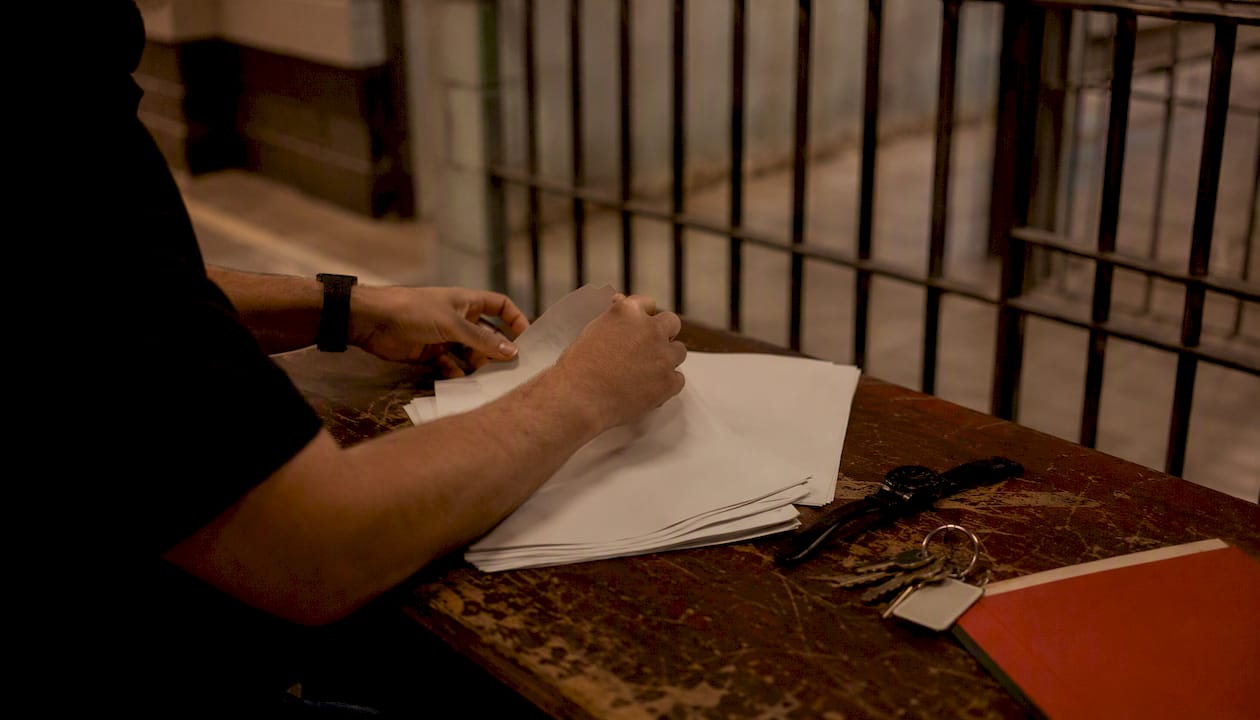 Hands with jail booking forms and keys