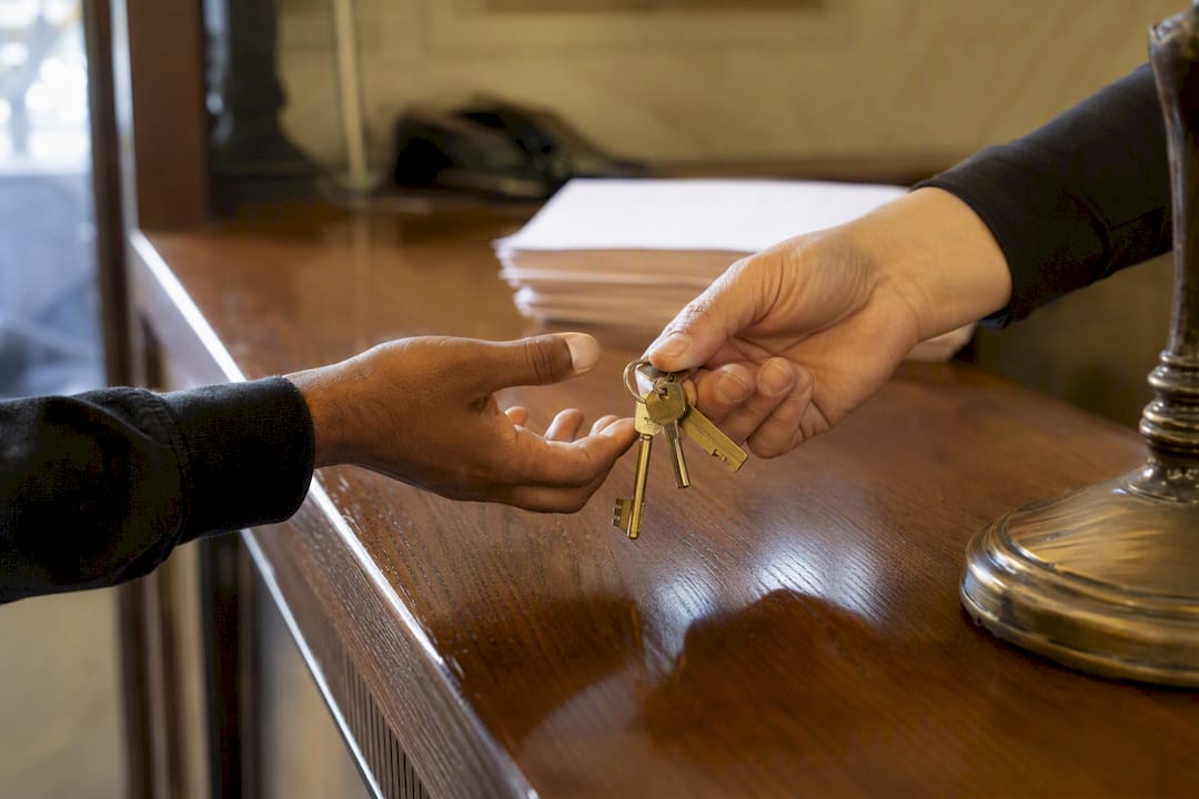 Hands exchanging jail release keys at bail office