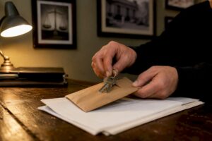 Hands exchanging keys and bail envelope