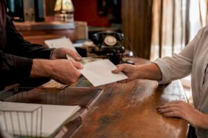 Hands exchanging cash and envelope at bail agency desk